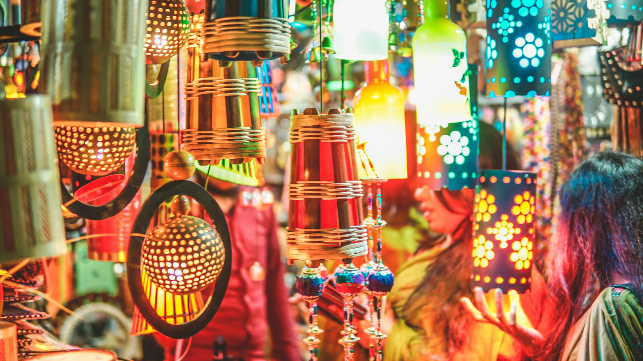 Colorful handmade lanterns at a vibrant festival market showcasing cultural crafts.