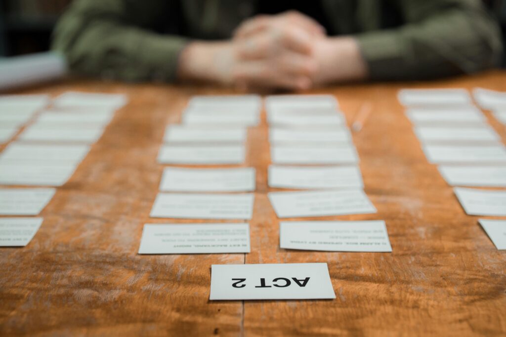Close-up of storyboard cards arranged on a table for scriptwriting planning.