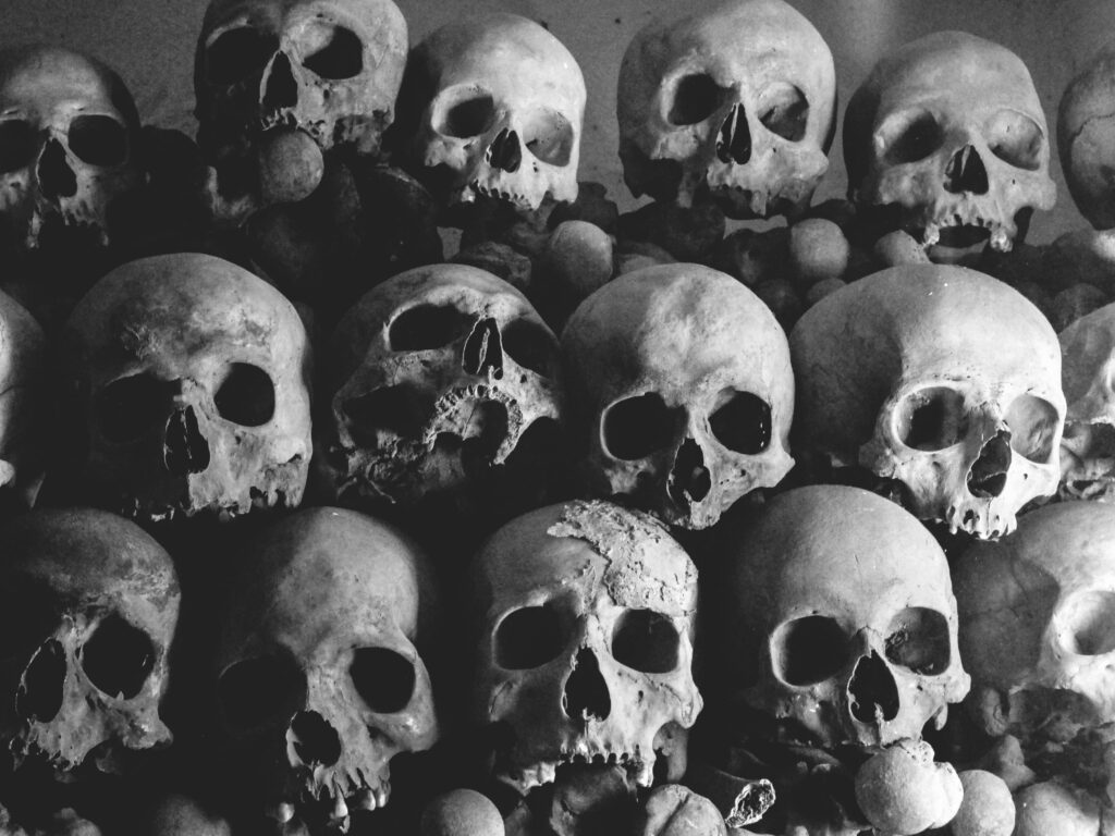 Dark and haunting pile of human skulls creating a creepy atmosphere.