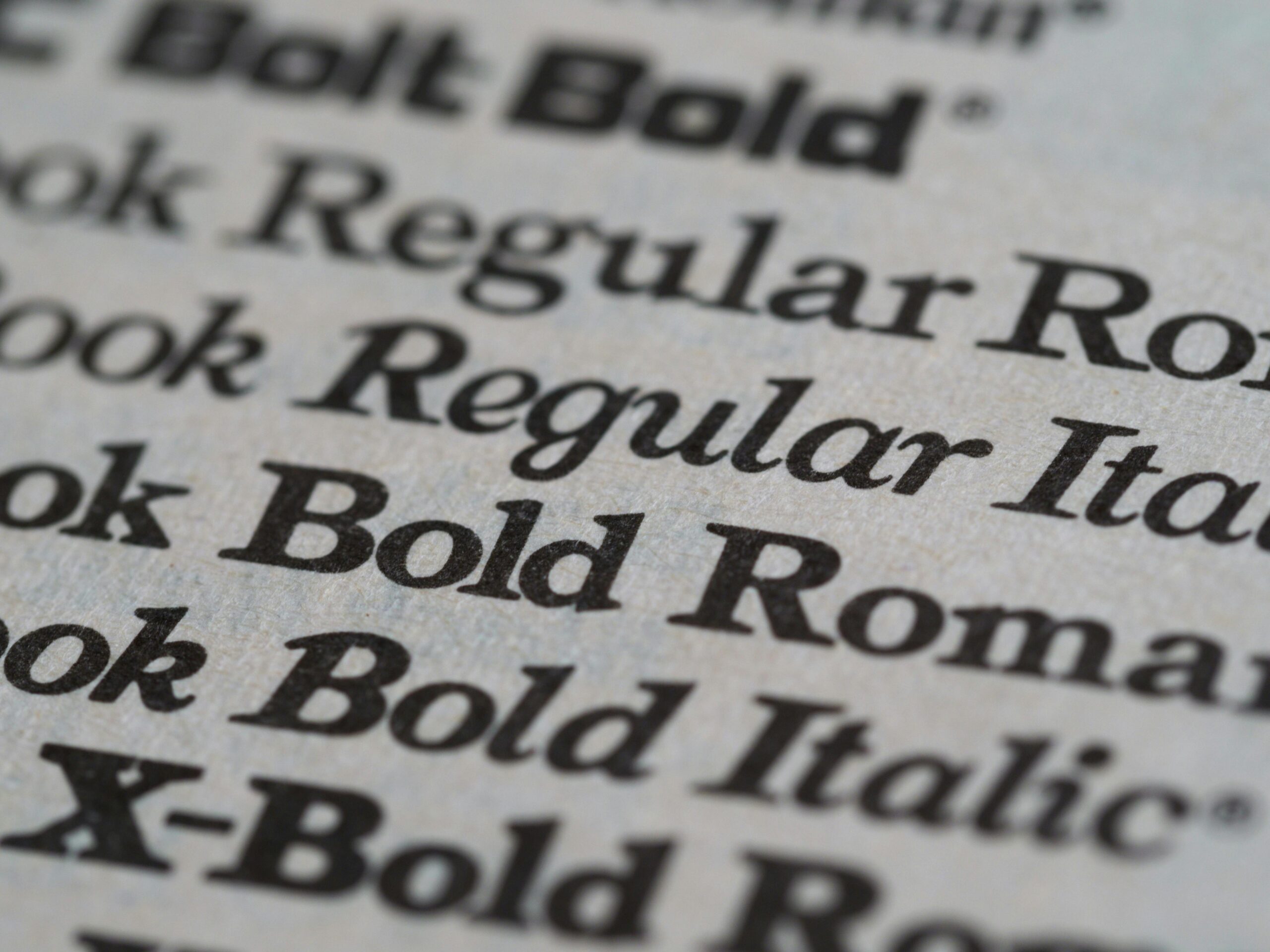 Detailed view of different font styles printed on paper, showcasing typography.